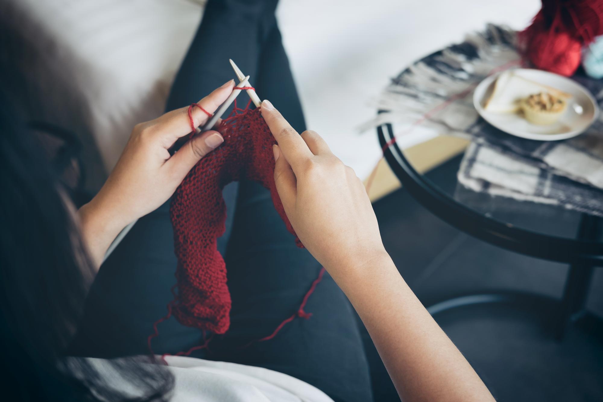 artisan at work stitching a motif